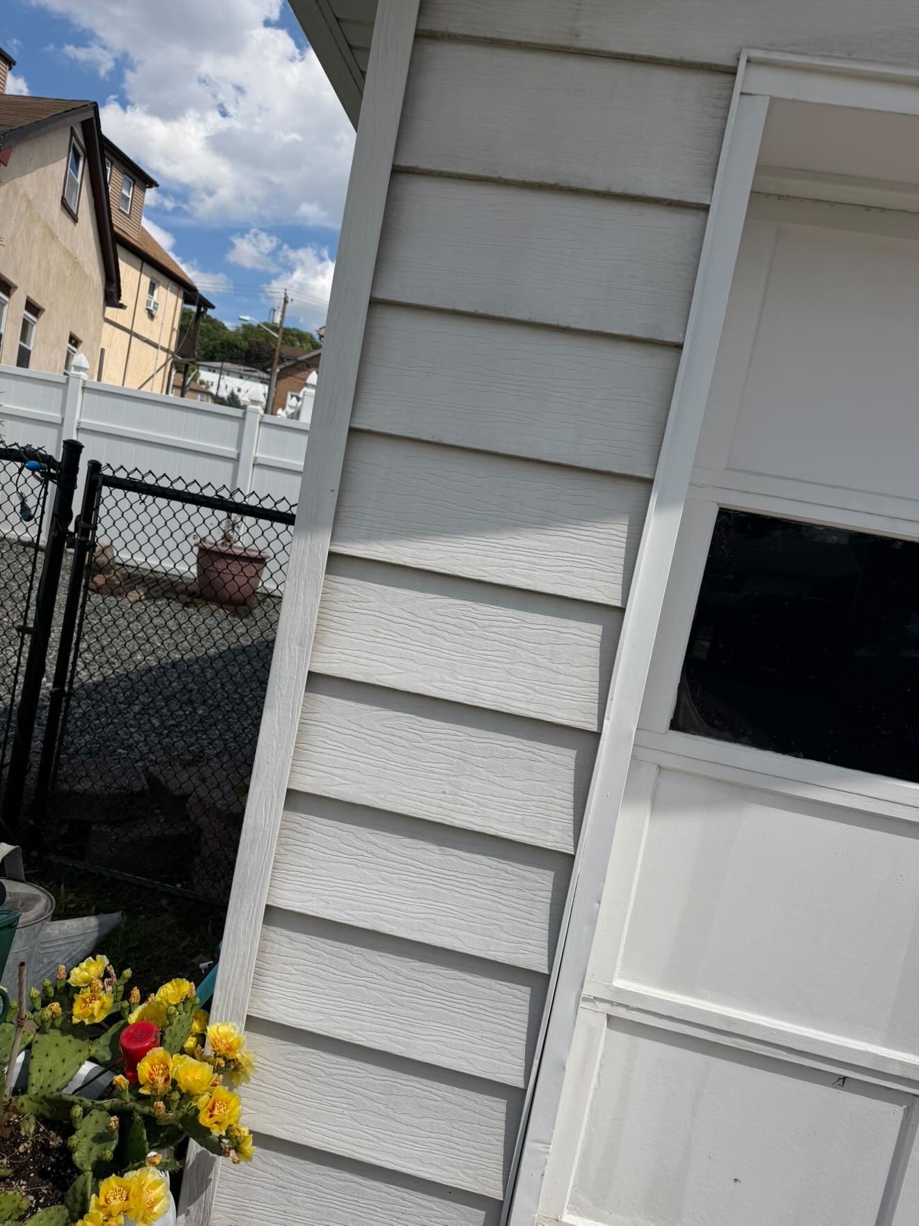 Weathered dark fence before pressure washing